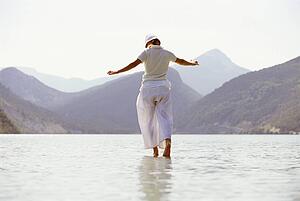 Woman outdoors walking on water in scenic location