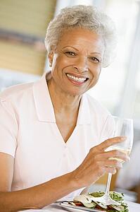 Woman Enjoying meal, mealtime With A Glass Of Wine