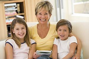 Grandmother reading with grandchildren.