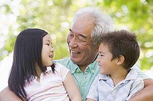 Grandfather laughing with grandchildren.