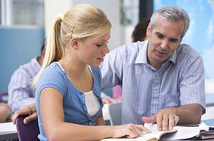 Teacher giving personal instruction to female student