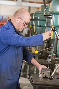 Machinist working on machine