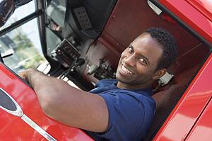 Fireman in driver's seat of fire engine