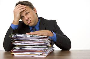 Businessman Overwhelmed By Paperwork