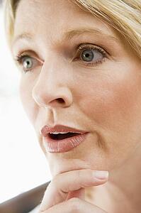 Head shot of woman thinking