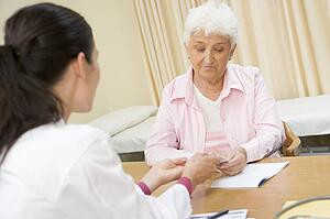Woman in doctor's office frowning