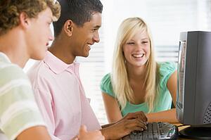 Teenagers Using Desktop Computer Together