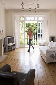 Woman in living room talking on telephone