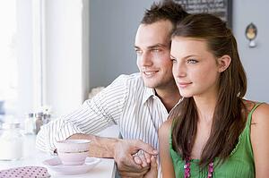 Young couple having a cold drink in a cafeteria