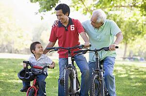 Grandfather son and grandson bike riding.