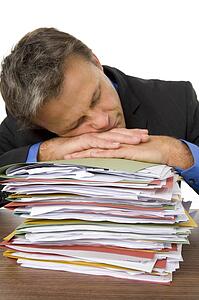 Businessman Overwhelmed By Paperwork