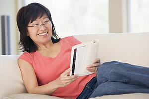 Woman relaxing with a book and smiling