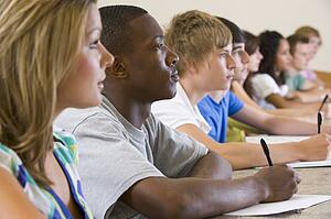 Students in class paying attention and taking notes (selective focus)