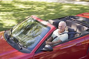 Man in convertible car smiling