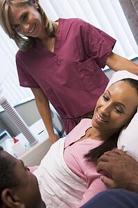 Woman having eggs retrieved from ovary using vaginal ultrasound