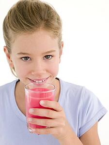 Young girl with glass of juice smiling