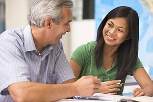 Teacher giving personal instruction to female student