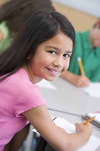 Student in class looking at camera (selective focus)