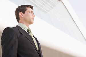 Businessman standing outdoors by building