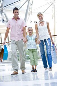 Mother and father with young daughter at a shopping mall