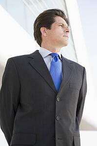 Businessman standing outdoors by building