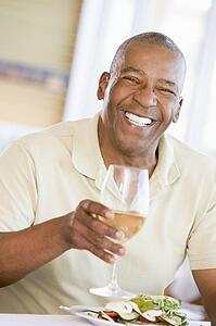 Man Enjoying meal, mealtime With A Glass Of Wine 