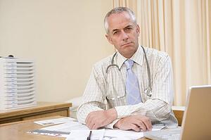 Doctor with laptop in doctor's office