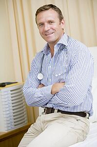 A Doctor Sitting On A Hospital Bed