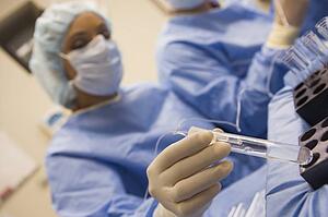 Nurse assisting with egg retrieval procedure