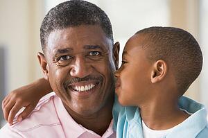 Grandfather and grandson hugging.