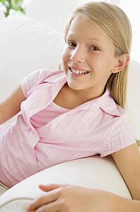Young Girl Sitting On A Sofa