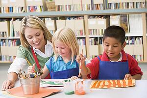 Two students in art class with teacher