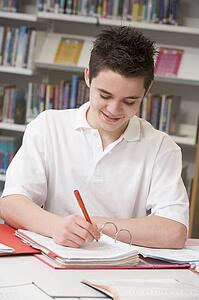 Student writing and studying