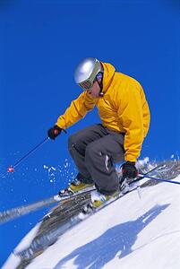 Skier jumping on snowy hill (blur)