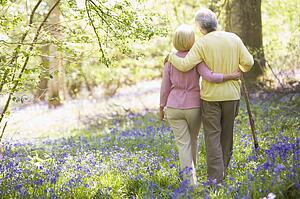 Couple walking outdoors with walking stick