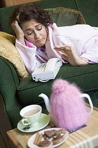 Young woman at home waiting by telephone