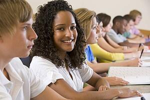Students in class paying attention and taking notes (selective focus)