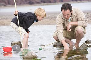 Father and son at beach fishing