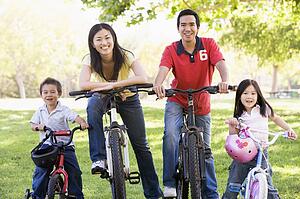 Family on bikes outdoors smiling
