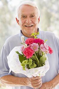 Man holding flowers and smiling