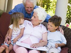 Grandparents reading to grandchildren.