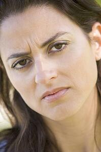 Head shot of woman scowling