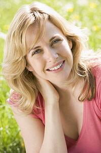 Woman sitting outdoors smiling
