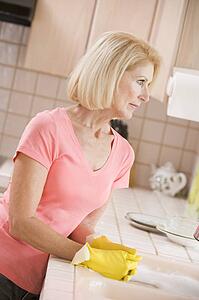 Woman Cleaning Kitchen Counter