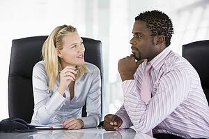 Two businesspeople in office talking