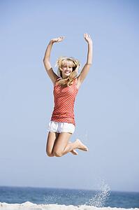 Woman jumping on a beach