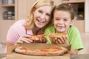 Mother And Son Eating Pizza Together