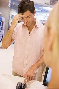Man trying to remember credit card PIN number