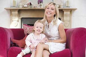 Mother in living room with baby smiling