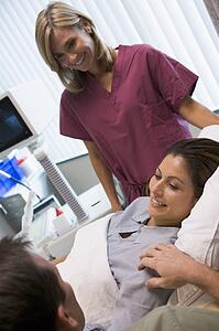 Woman having eggs retrieved from ovary using vaginal ultrasound